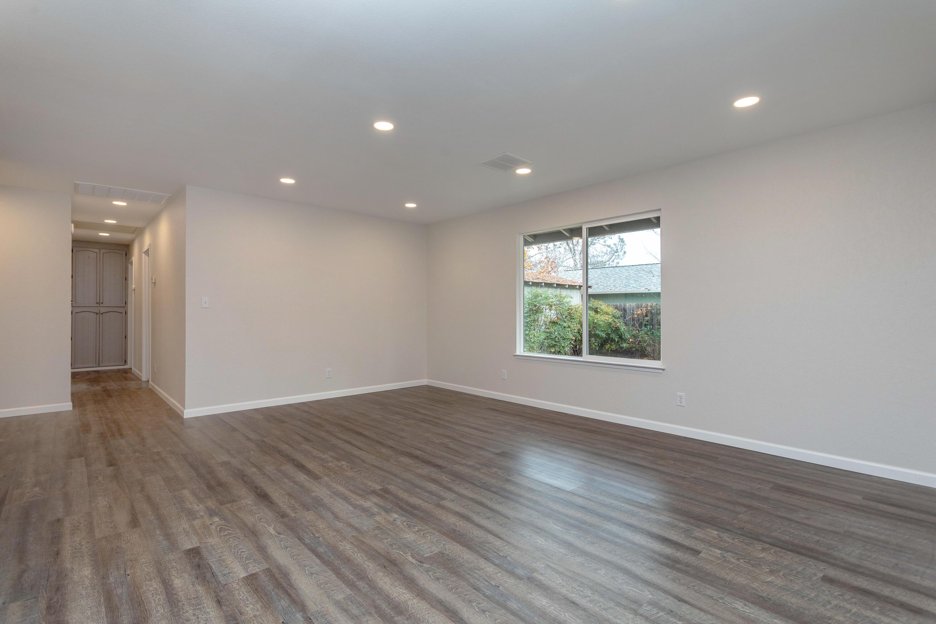 3693 Echo Road Redding, CA 96002 - Photo 3 of 30 an empty room with wooden floor and windows