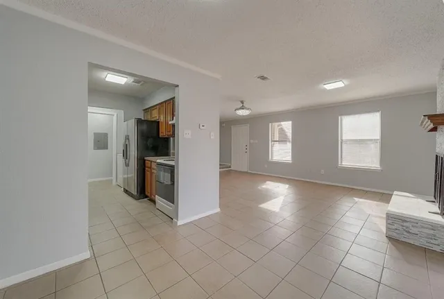 a view of a kitchen with furniture and an empty room