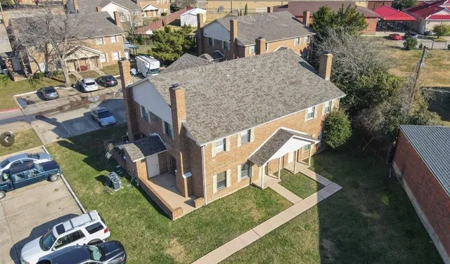 an aerial view of a house with a yard