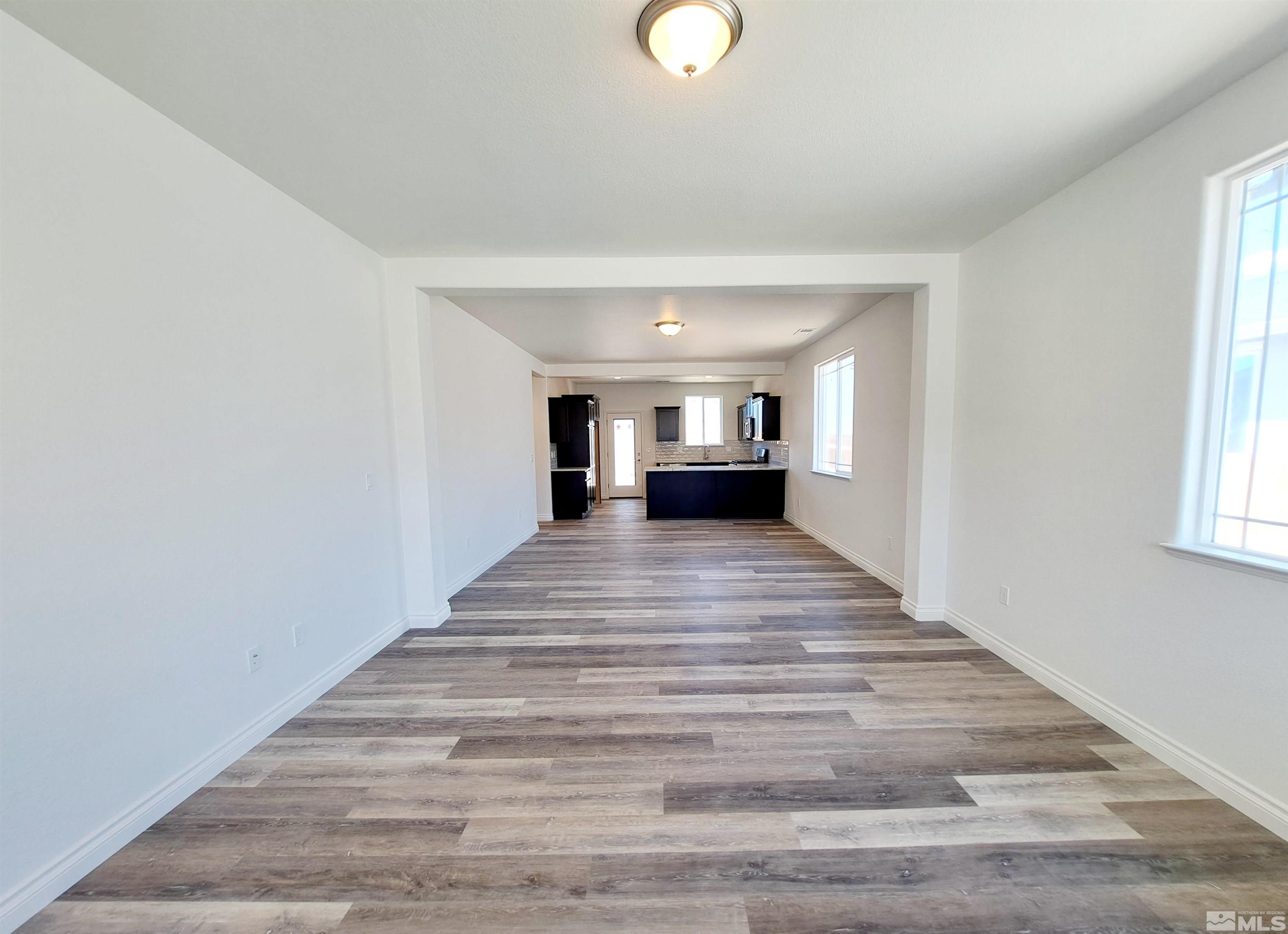19013 Alpine Walk Court, Unit LOT 1881 Reno, NV 89508 - Photo 2 of 26 a view of an entryway with wooden floor and windows