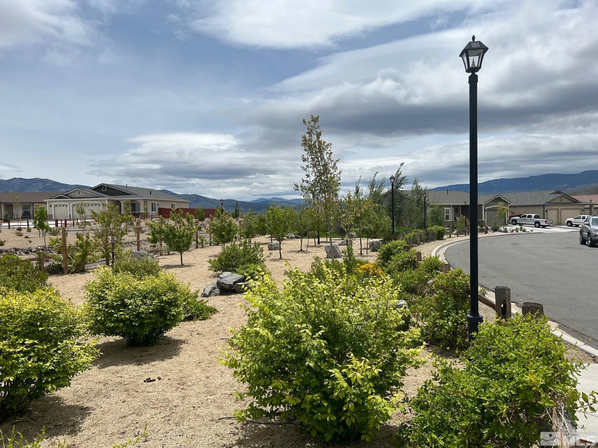 19013 Alpine Walk Court, Unit LOT 1881 Reno, NV 89508 - Photo 22 of 26 a view of a lake with a city