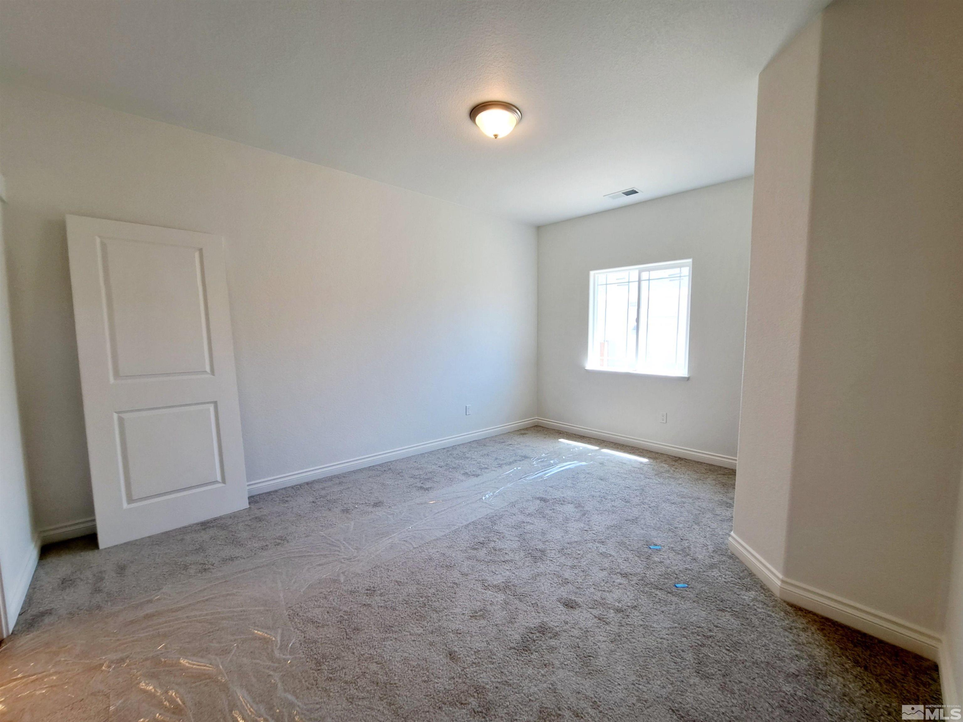 19013 Alpine Walk Court, Unit LOT 1881 Reno, NV 89508 - Photo 5 of 26 an empty room with windows