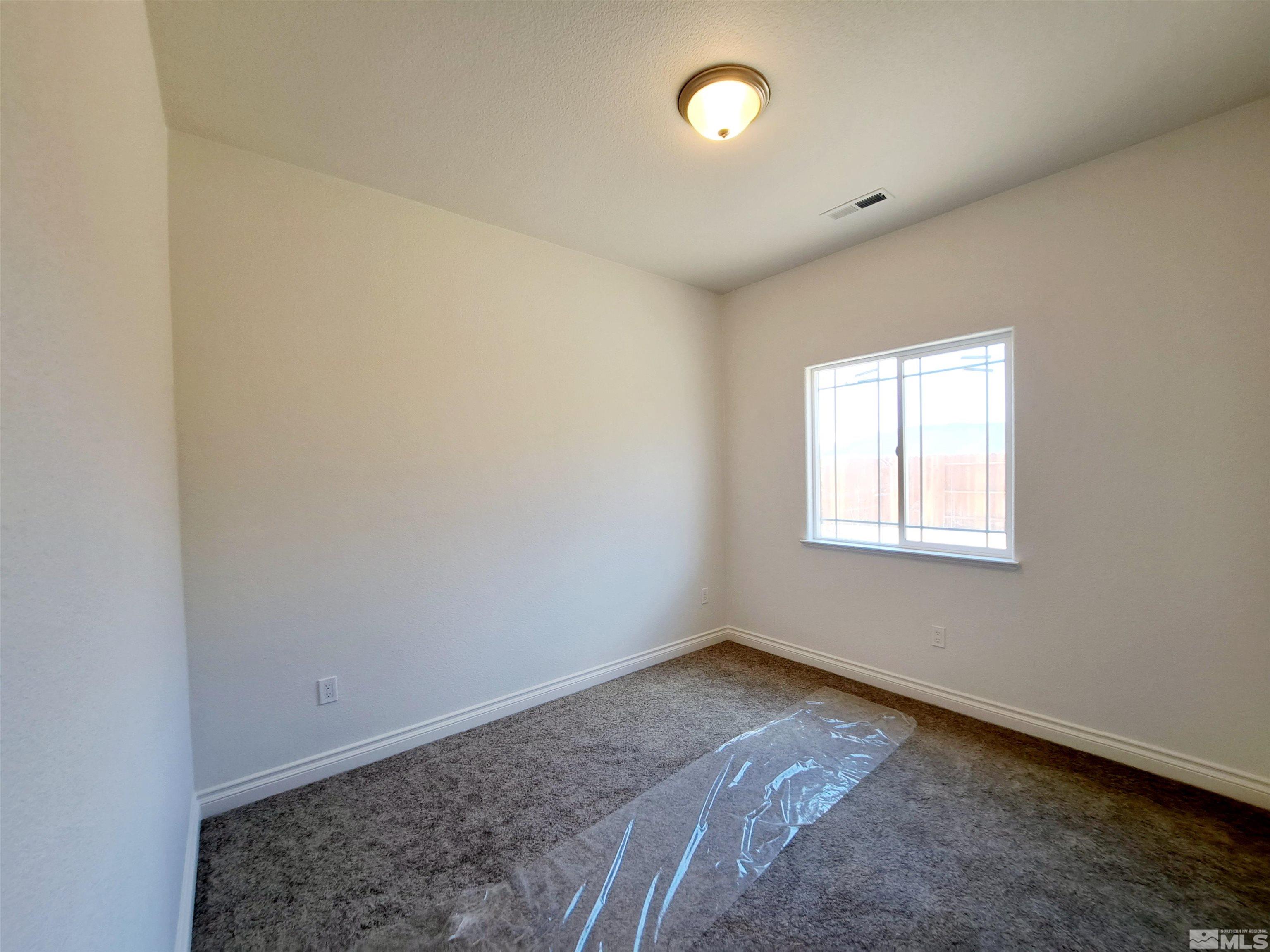 19013 Alpine Walk Court, Unit LOT 1881 Reno, NV 89508 - Photo 8 of 26 an empty room with a window
