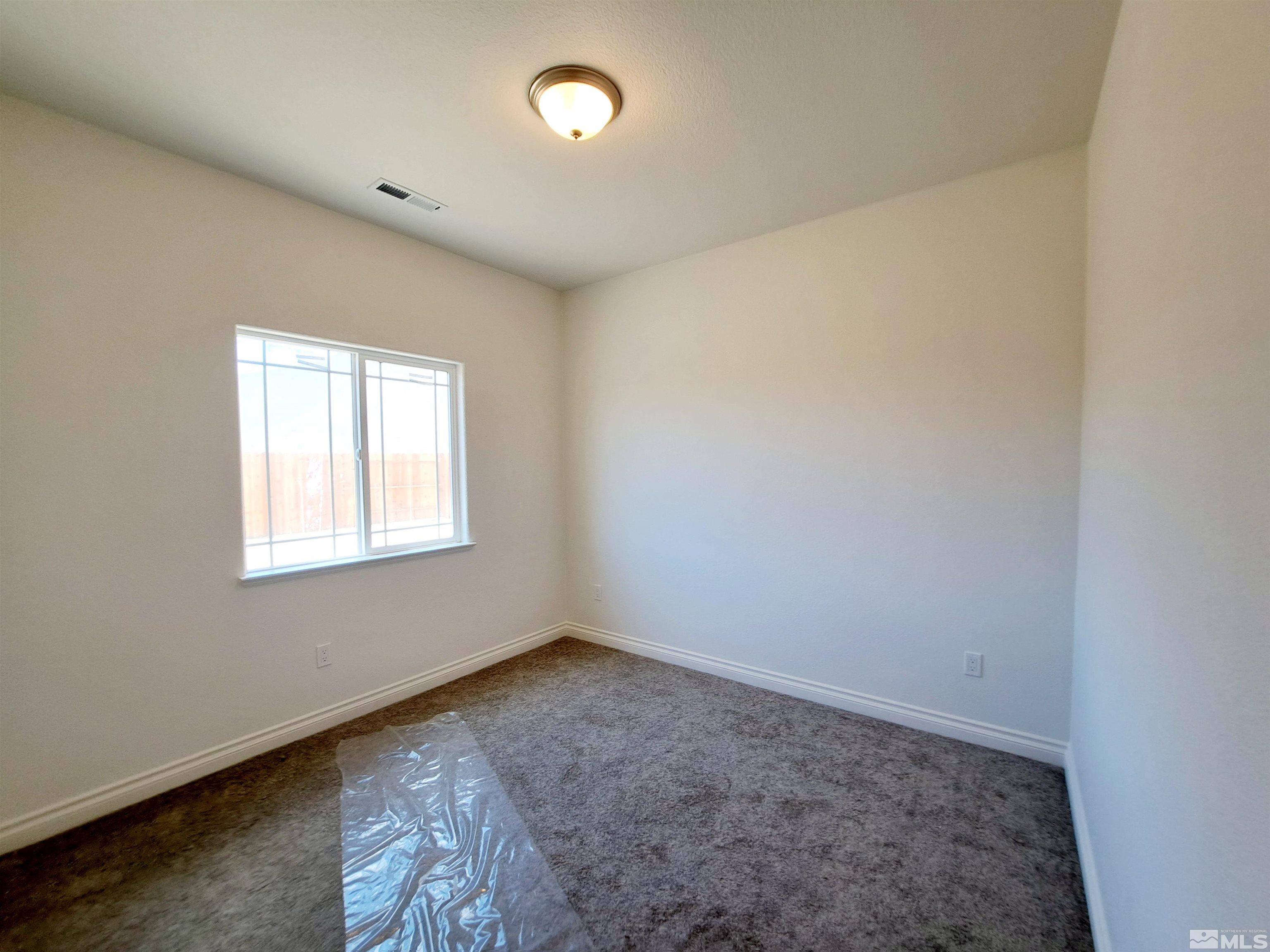 19013 Alpine Walk Court, Unit LOT 1881 Reno, NV 89508 - Photo 9 of 26 an empty room with a window