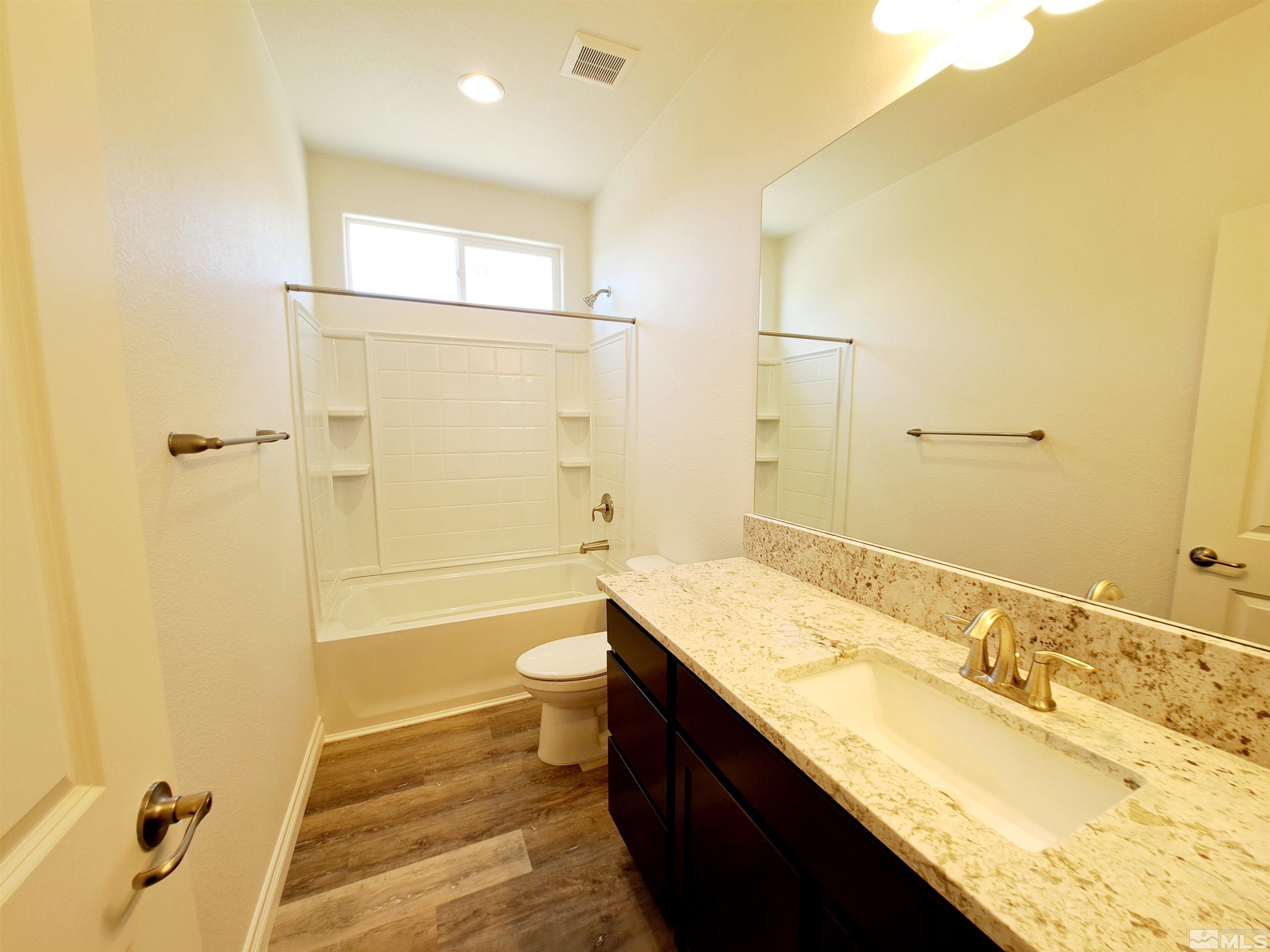 19013 Alpine Walk Court, Unit LOT 1881 Reno, NV 89508 - Photo 10 of 26 a bathroom with a granite countertop sink toilet and shower