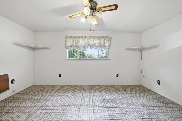 a view of room with a ceiling fan and window