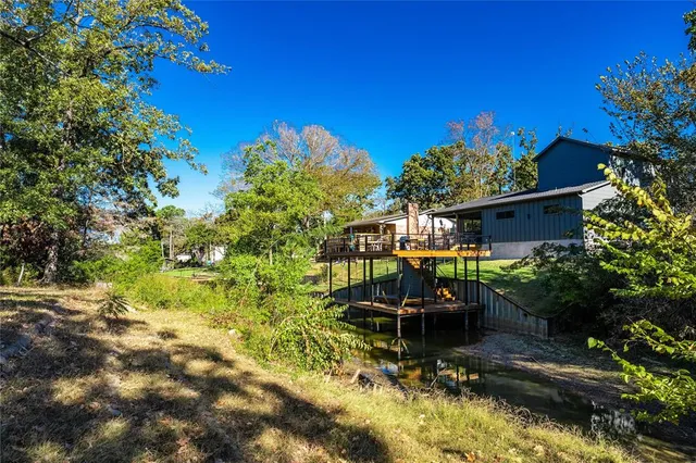 a backyard of a house with yard table and chairs