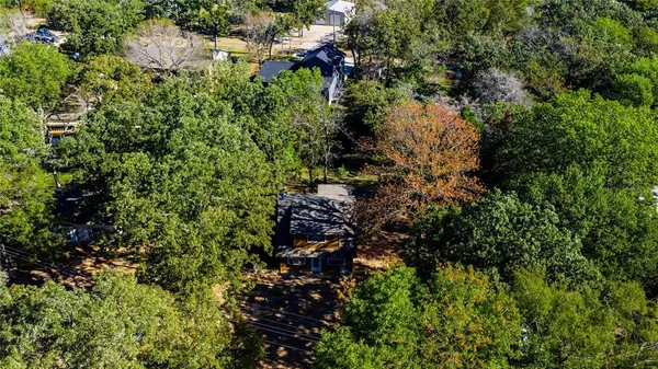 an aerial view of a houses with yard