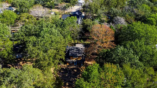an aerial view of a houses with yard