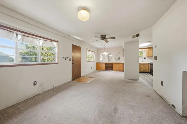 a view of a livingroom with furniture and a window
