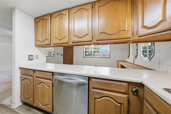 a kitchen with stainless steel appliances granite countertop a sink and cabinets with wooden floor