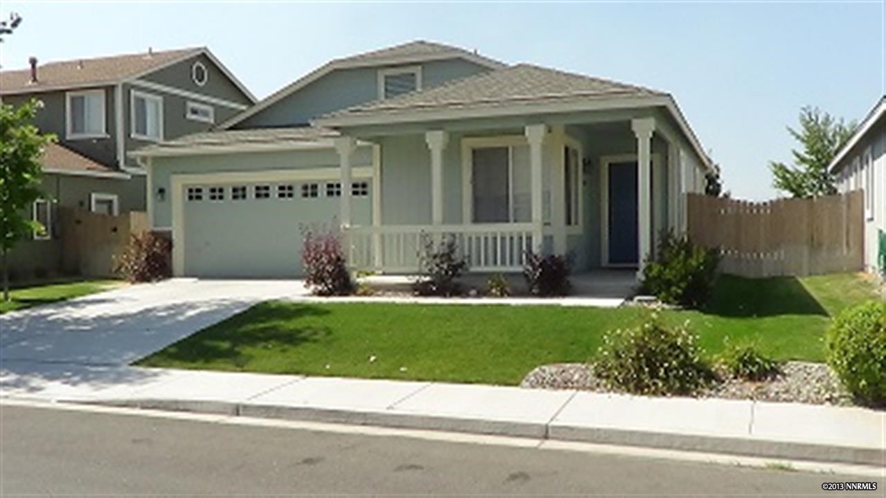a front view of a house with a yard and potted plants