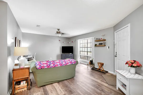 a living room with furniture and a wooden floor