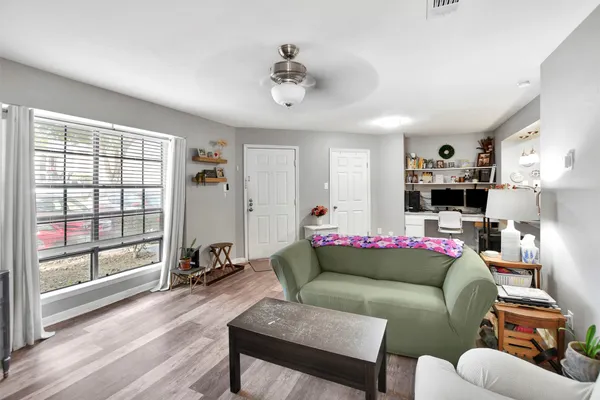a living room with furniture and a large window