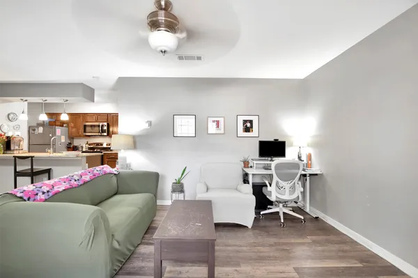 a living room with furniture and a dining table