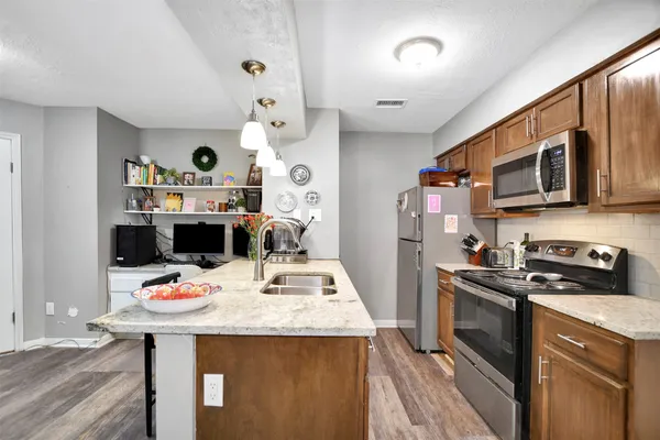 a kitchen with a sink stove and cabinets