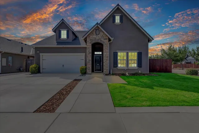 a front view of a house with garden