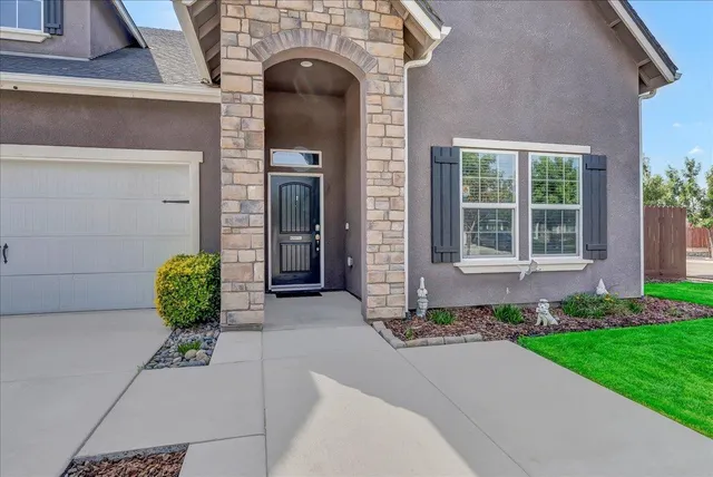 a view of a livingroom with furniture staircase and a kitchen