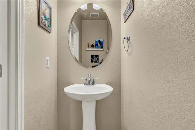 a kitchen with stainless steel appliances a stove a sink dishwasher a refrigerator and a microwave oven with wooden floor