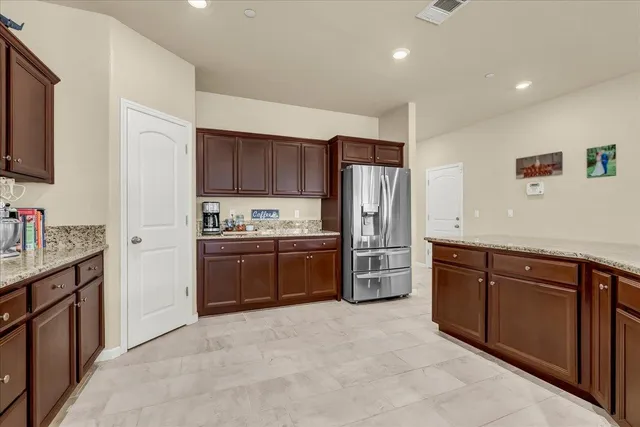 a living room with furniture kitchen view and a wooden floor