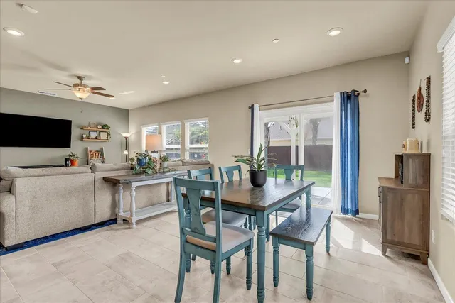 a living room with furniture a flat screen tv and a large window