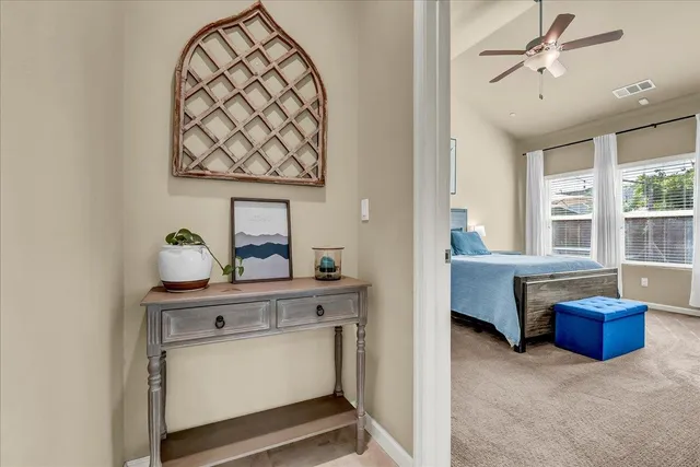 a spacious bathroom with a granite countertop double vanity sink a mirror and a bathtub