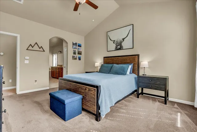 a bed room with a bed and a chandelier