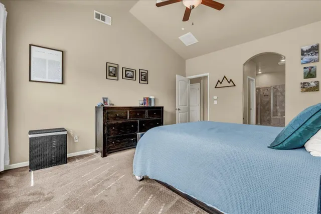 a bedroom with a bed and a ceiling fan