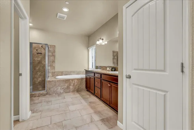 a bathroom with a granite countertop sink a toilet and a mirror
