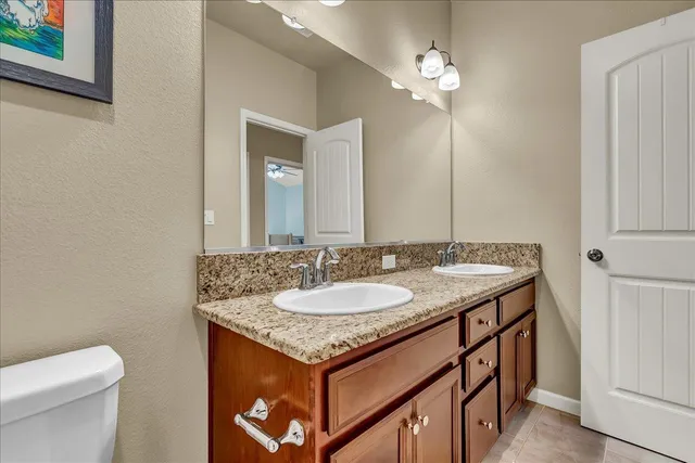 a front view of a house with a yard and potted plants