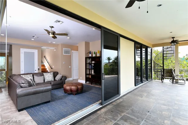a living room with furniture and large windows
