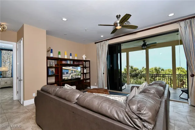 a living room with furniture and a ceiling fan