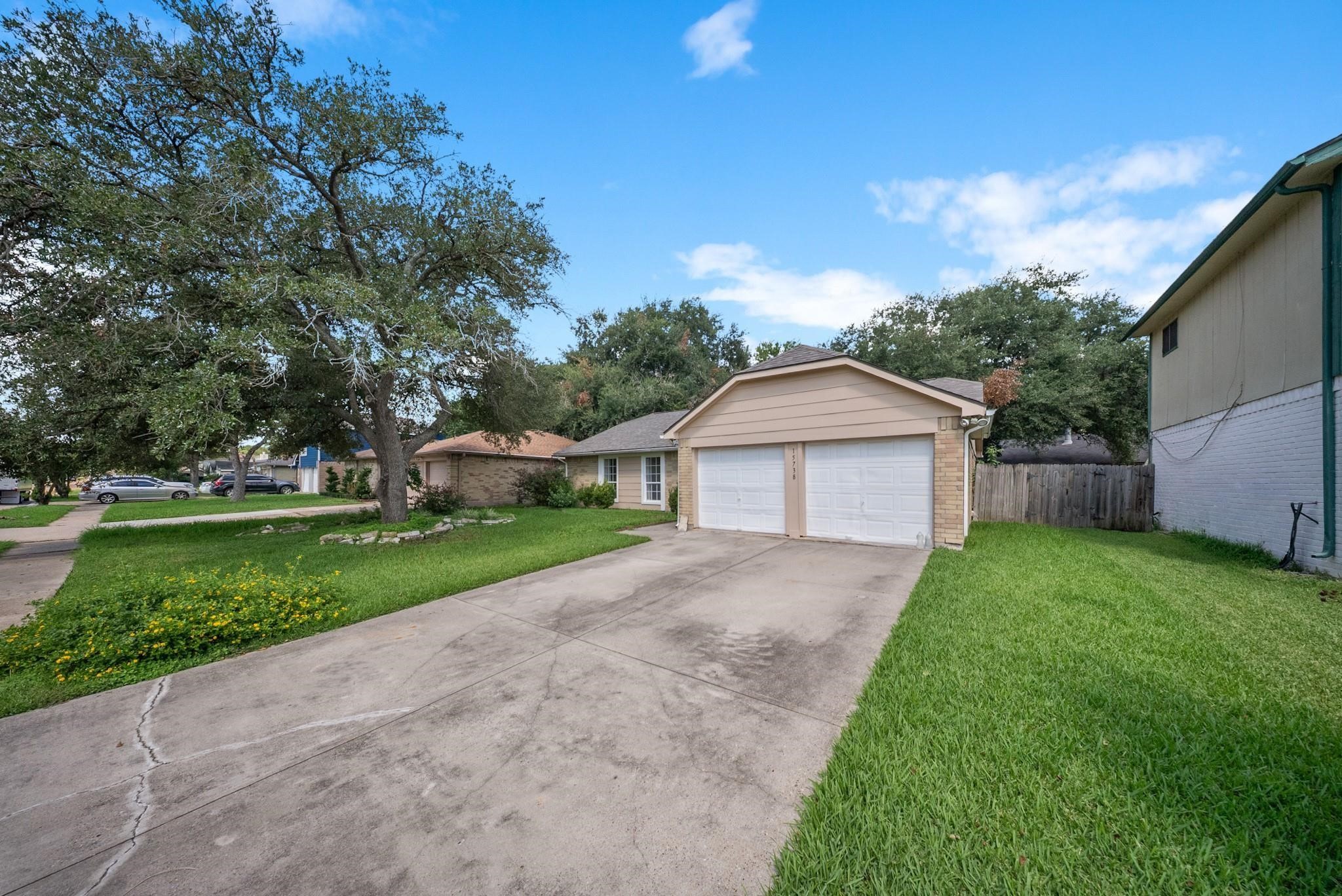 15738 Tammany Lane Houston, TX 77082 - Photo 2 of 22 a view of a house with a yard and large trees