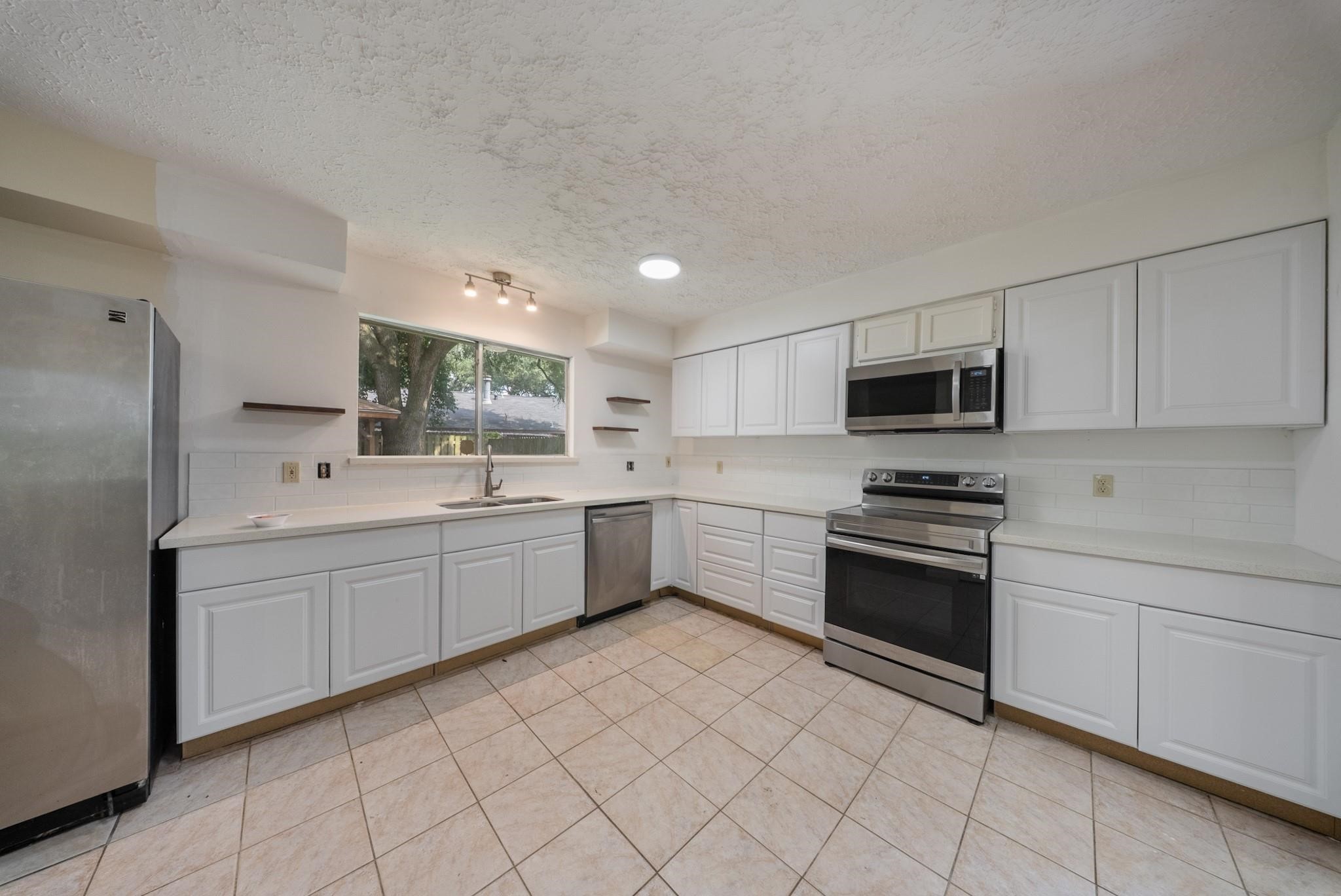 15738 Tammany Lane Houston, TX 77082 - Photo 22 of 22 a kitchen with a sink appliances and cabinets