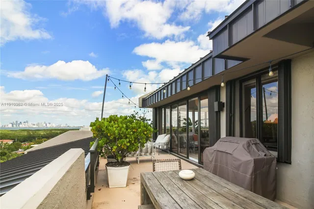 a outdoor space with lots of tables a large window and chairs