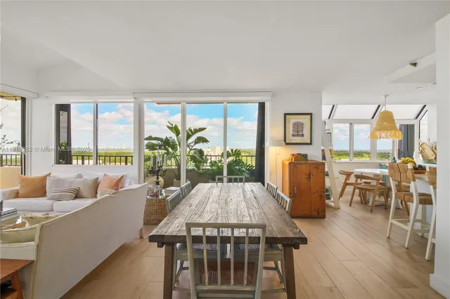 a view of living room with patio furniture and floor to ceiling windows