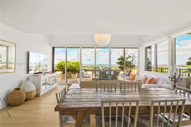 a kitchen with stainless steel appliances a white table and chairs in it