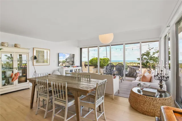 a kitchen with stainless steel appliances granite countertop a sink a stove and white cabinets with wooden floor