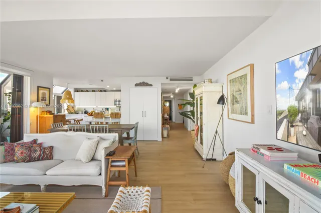 a view of a dining room with furniture large windows and wooden floor