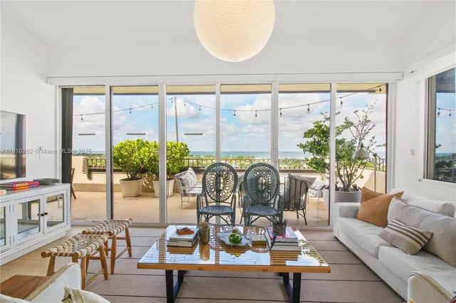 a kitchen with a sink dishwasher a dining table and chairs with wooden floor
