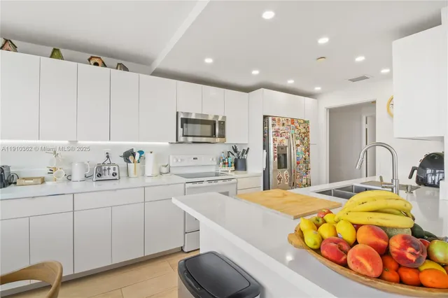 a bed room with a bed and painting on the wall