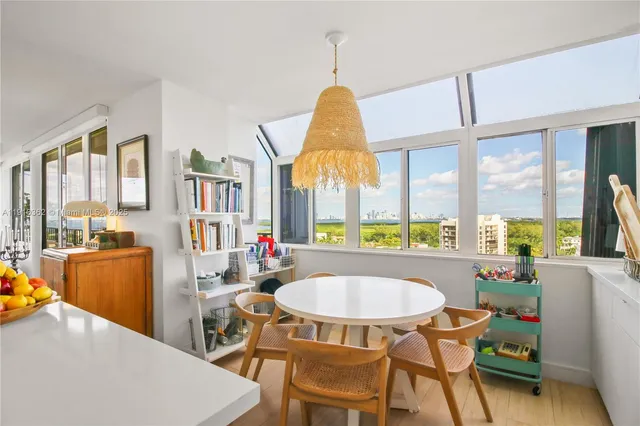 a living room with furniture a rug and a large window