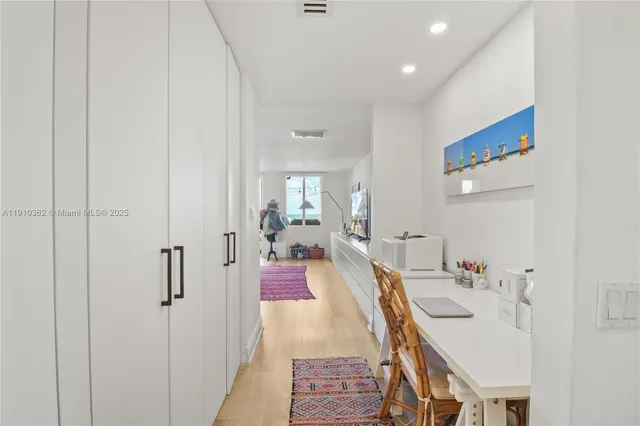 a kitchen with stainless steel appliances kitchen island granite countertop a table and chairs