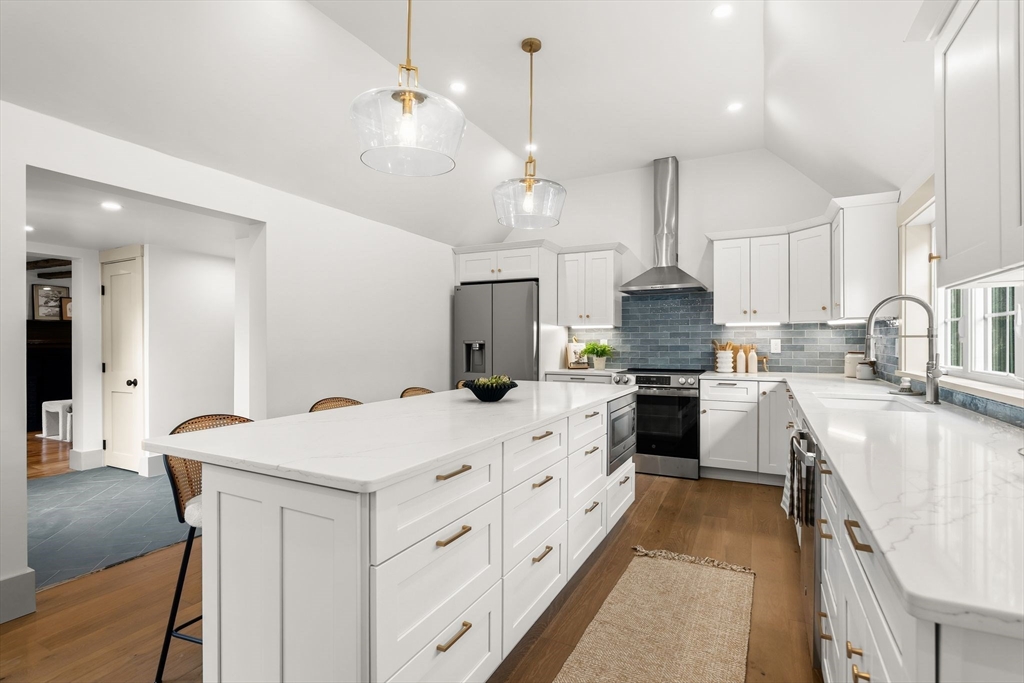 118 Hanover Street Hanover, MA 02339 - Photo 11 of 41 a kitchen with kitchen island a stove a sink a center island and cabinets