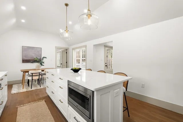 a view of kitchen with sink microwave and dining table