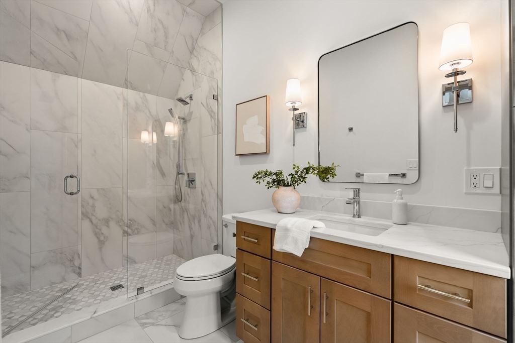 118 Hanover Street Hanover, MA 02339 - Photo 30 of 41 a bathroom with a granite countertop sink a toilet and shower