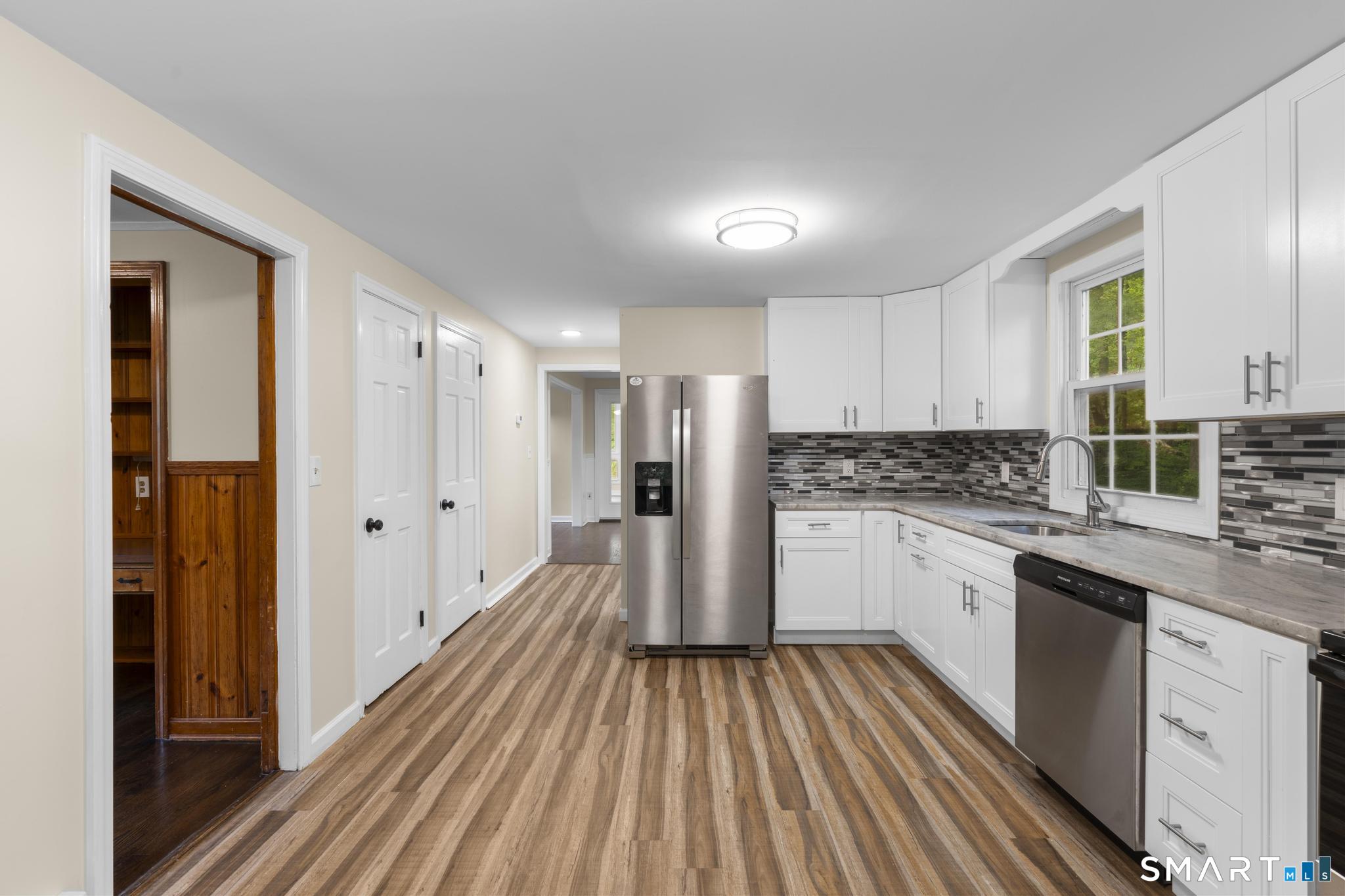 7 Sycamore Terrace Windham, CT 06280 - Photo 11 of 40 a kitchen with white cabinets sink and stainless steel appliances