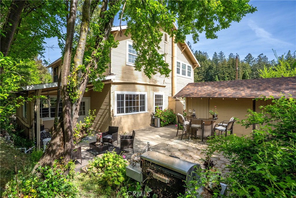 a view of a house with backyard sitting area and garden