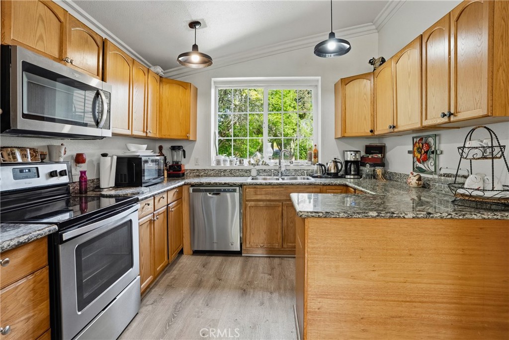 6701 East Zayante Road Felton, CA 95018 - Photo 14 of 44 a kitchen with stainless steel appliances granite countertop a sink a stove cabinets counter space and a window