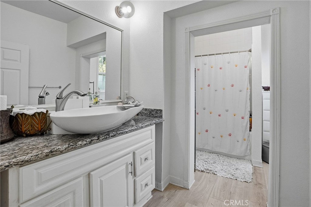 6701 East Zayante Road Felton, CA 95018 - Photo 19 of 44 a bathroom with a granite countertop sink and a mirror